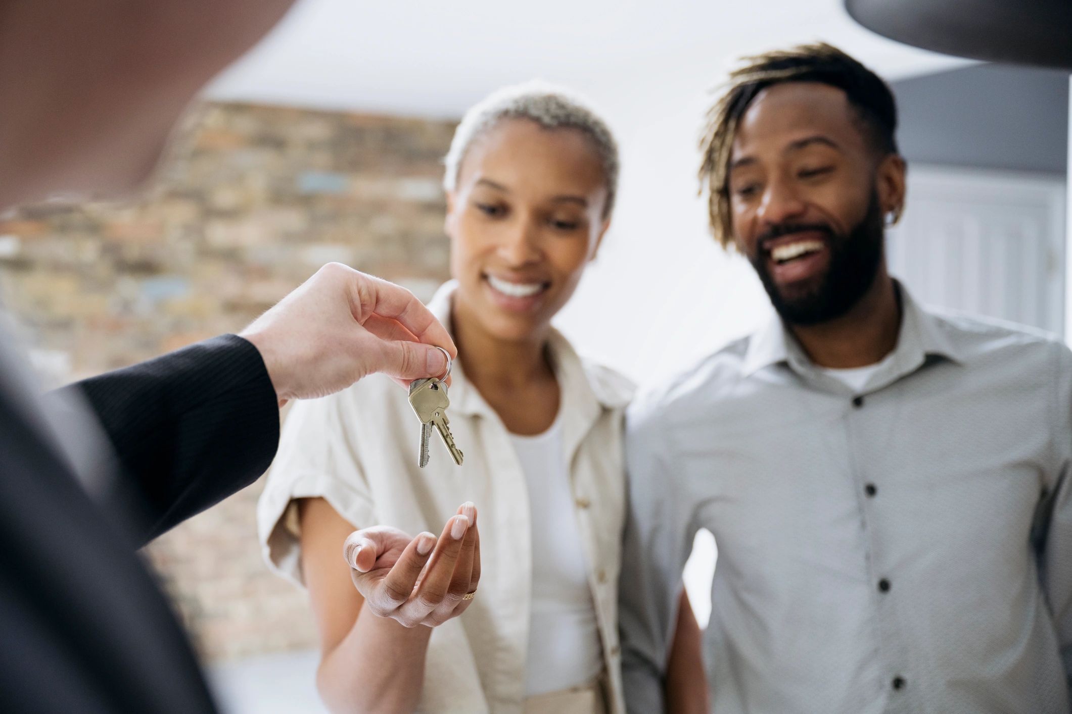 Happy homeowners celebrating with keys