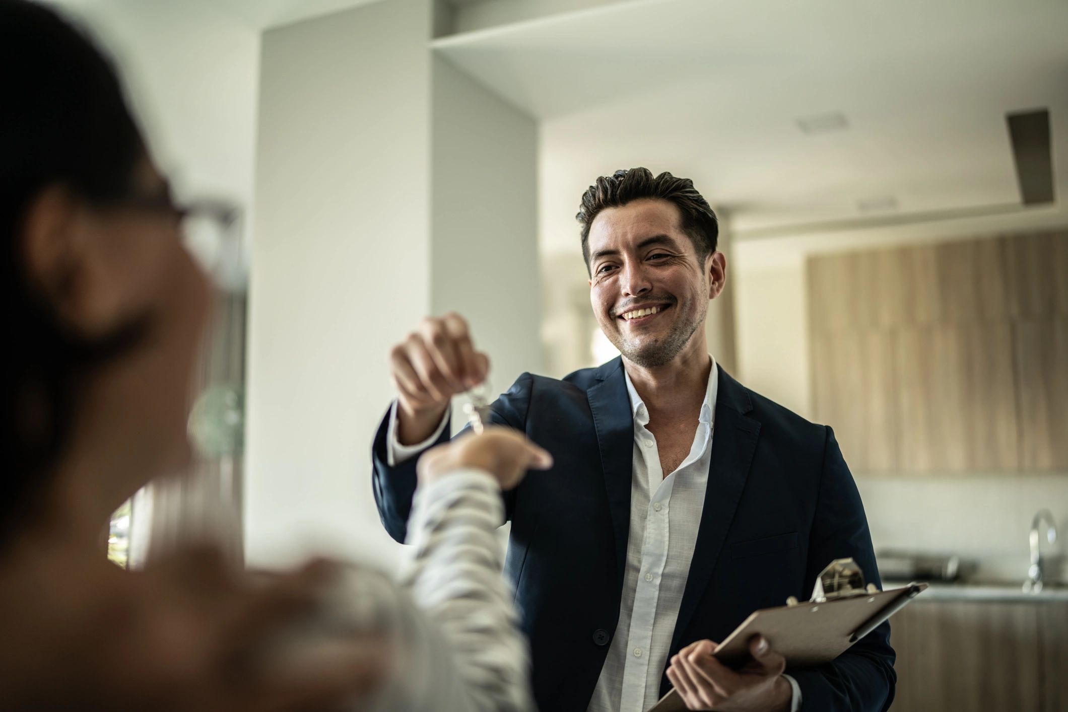 Client receiving keys from a real estate agent