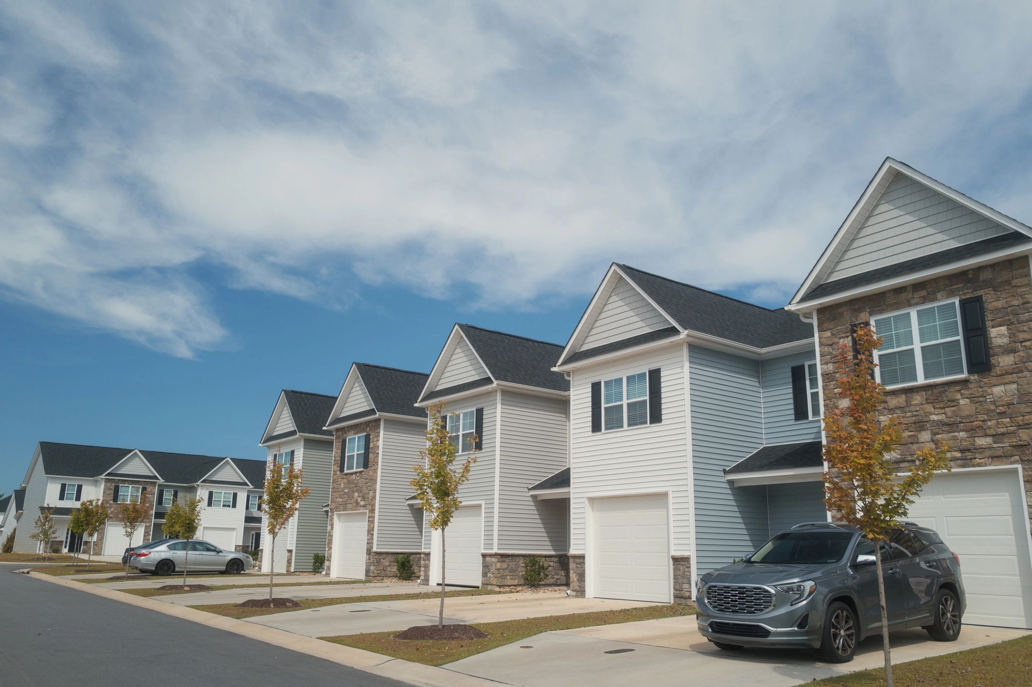 Row of townhouses under a blue sky
